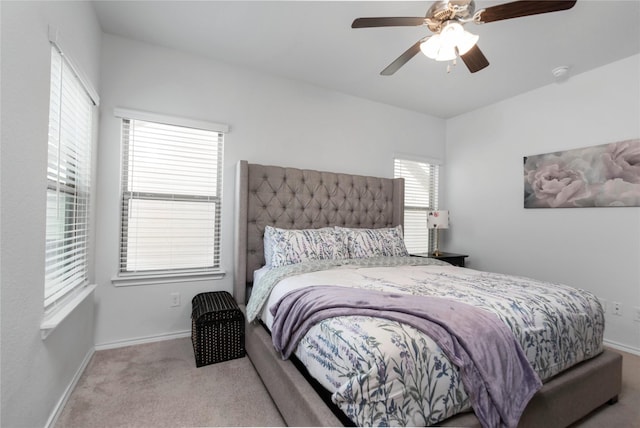 bedroom with ceiling fan, baseboards, and carpet