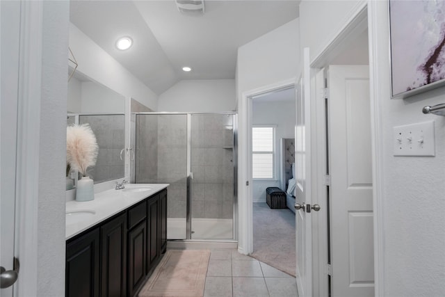 bathroom featuring a sink, a shower stall, tile patterned floors, and double vanity