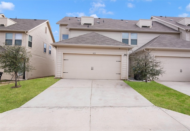 view of front of home with concrete driveway, a garage, roof with shingles, and a front lawn