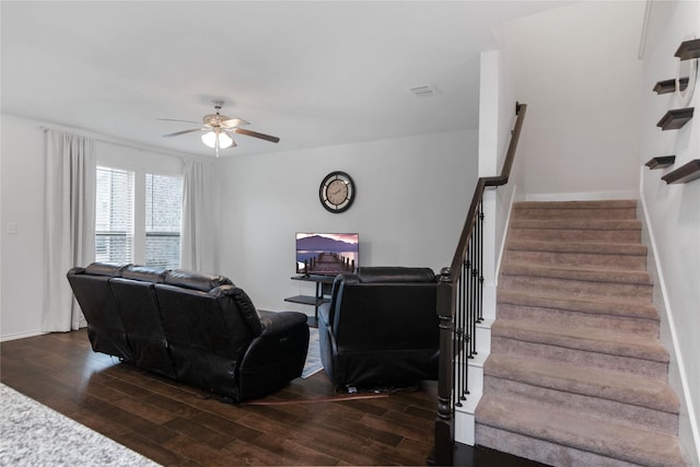 living room featuring stairway, baseboards, ceiling fan, and dark wood-style flooring