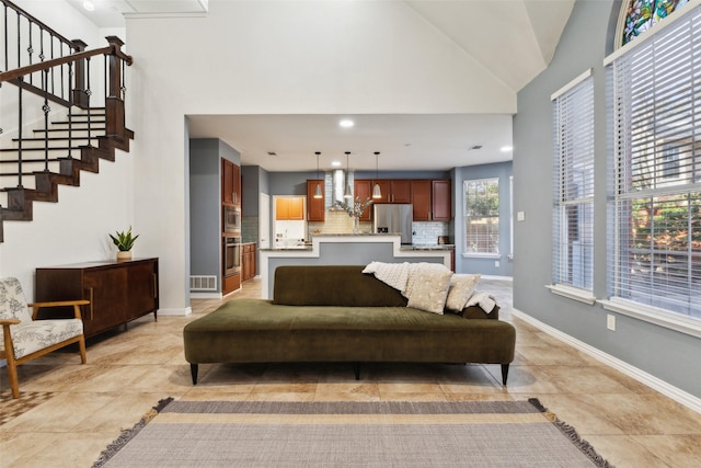 living room with baseboards, stairway, recessed lighting, light tile patterned flooring, and high vaulted ceiling