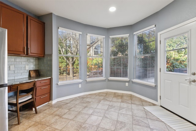 interior space with recessed lighting, baseboards, and built in study area