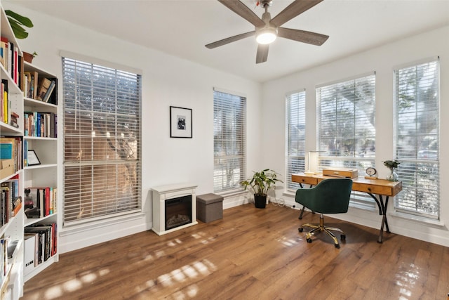 home office with wood finished floors, baseboards, and ceiling fan