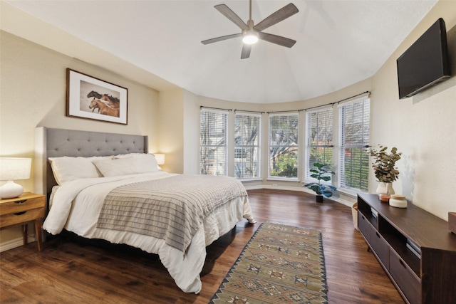 bedroom with lofted ceiling, baseboards, dark wood-style flooring, and ceiling fan