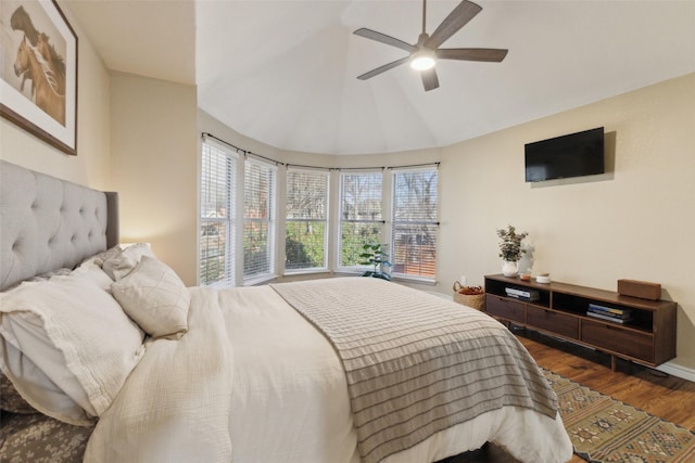 bedroom with high vaulted ceiling, wood finished floors, baseboards, and ceiling fan