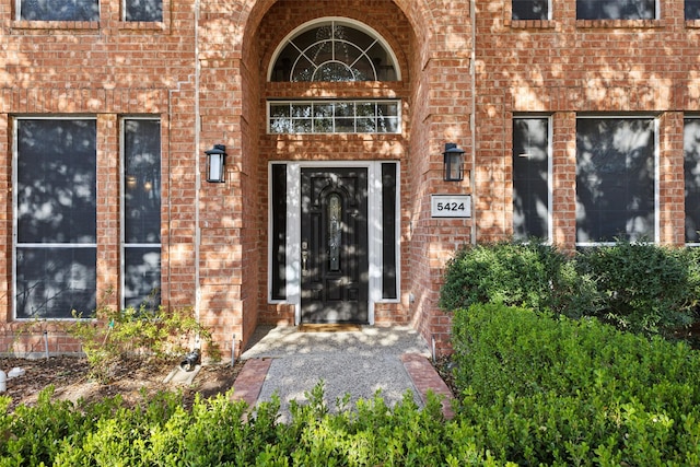 property entrance featuring brick siding