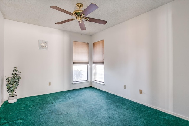 carpeted spare room with a ceiling fan, baseboards, and a textured ceiling