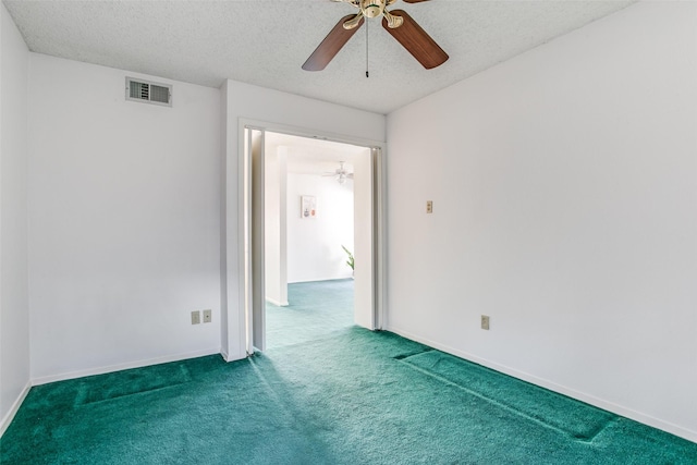 unfurnished room with visible vents, a textured ceiling, carpet, and ceiling fan