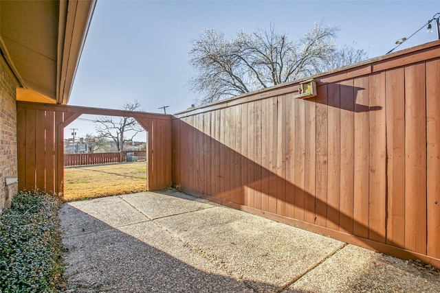 view of gate with a yard and fence