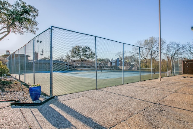 view of tennis court with fence