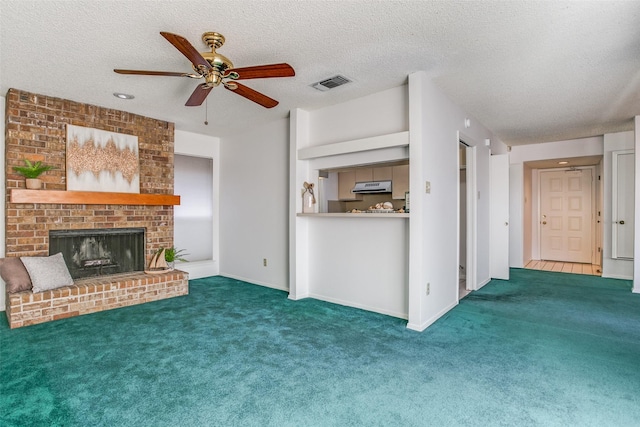 unfurnished living room featuring visible vents, a fireplace, a ceiling fan, and carpet