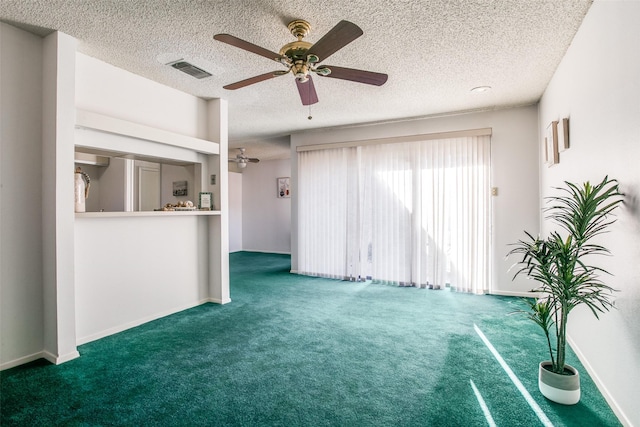 unfurnished living room featuring visible vents, baseboards, carpet, a textured ceiling, and a ceiling fan