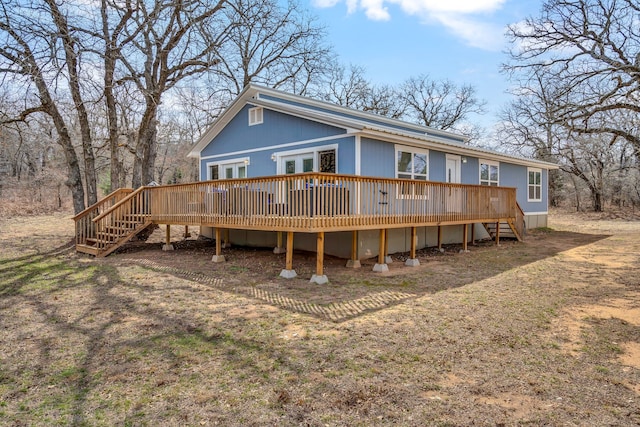 back of property with a wooden deck and stairs