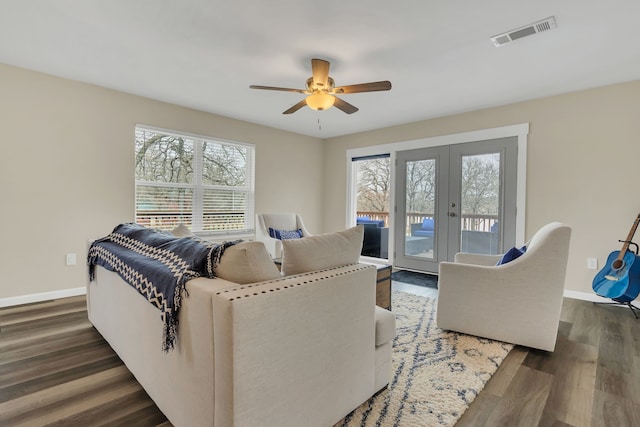 living room featuring baseboards, visible vents, ceiling fan, dark wood-type flooring, and french doors