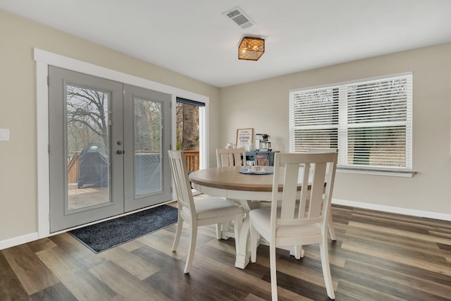 dining room with visible vents, a healthy amount of sunlight, french doors, and wood finished floors