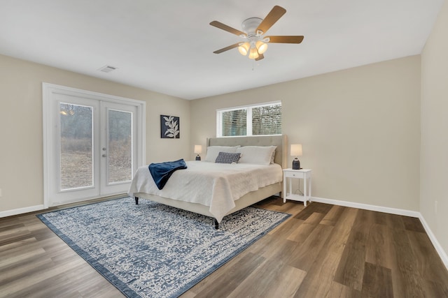 bedroom with visible vents, baseboards, wood finished floors, and french doors