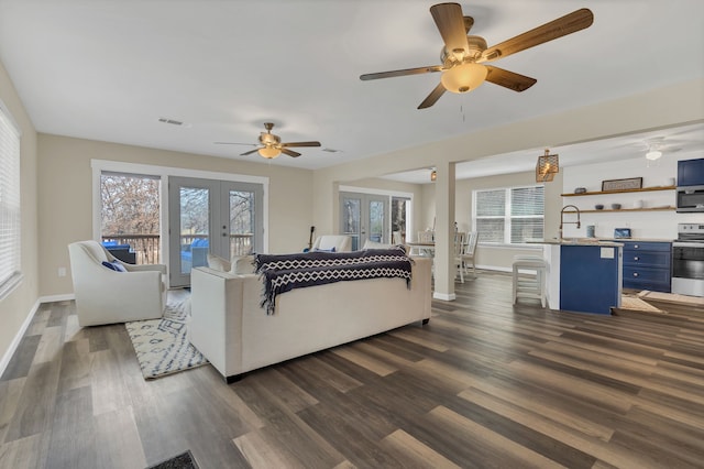 living room with dark wood finished floors, visible vents, french doors, and ceiling fan