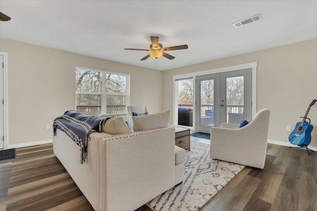 living room with visible vents, dark wood-type flooring, a ceiling fan, and french doors