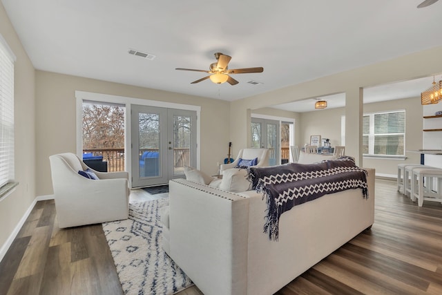 living area featuring a wealth of natural light, a ceiling fan, and wood finished floors