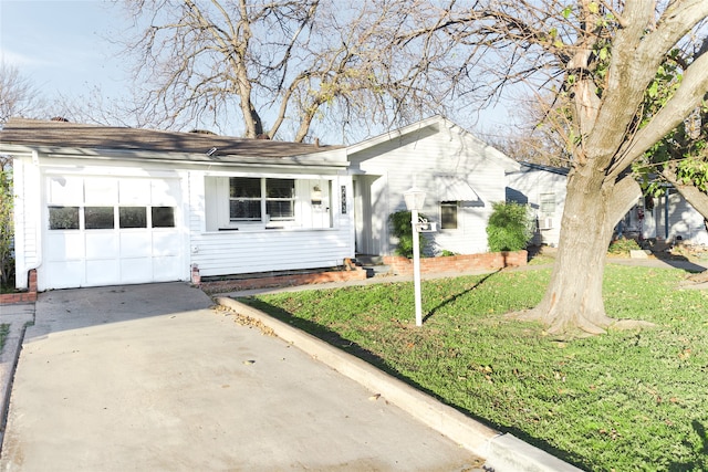 single story home featuring a garage, a front yard, and driveway