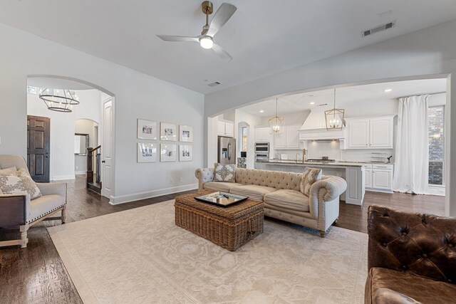 living room with visible vents, recessed lighting, arched walkways, ceiling fan, and dark wood-type flooring