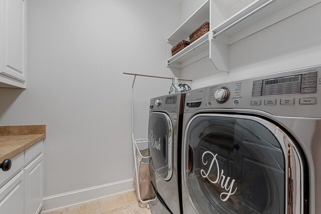 laundry area featuring cabinet space, washing machine and dryer, and baseboards