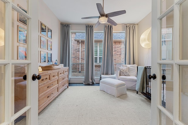 living area featuring french doors and ceiling fan