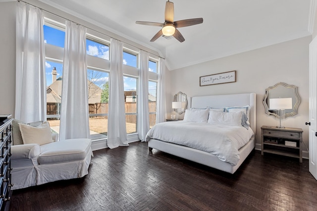 bedroom with lofted ceiling, ornamental molding, wood finished floors, and ceiling fan