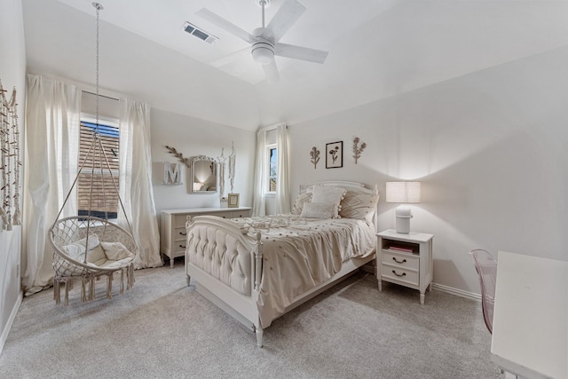 bedroom featuring visible vents, a ceiling fan, baseboards, lofted ceiling, and light colored carpet