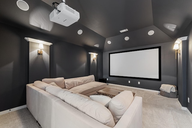 carpeted cinema featuring baseboards and vaulted ceiling