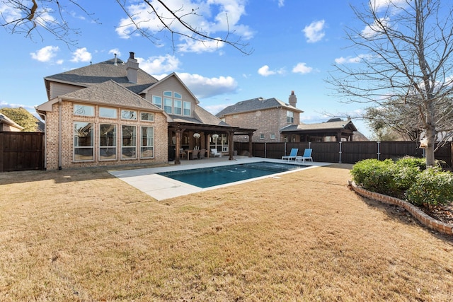 view of pool with a fenced backyard, a yard, a patio, and a fenced in pool