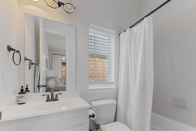 bathroom featuring vanity, shower / tub combo, and toilet