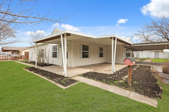 view of home's exterior with an attached carport and a lawn