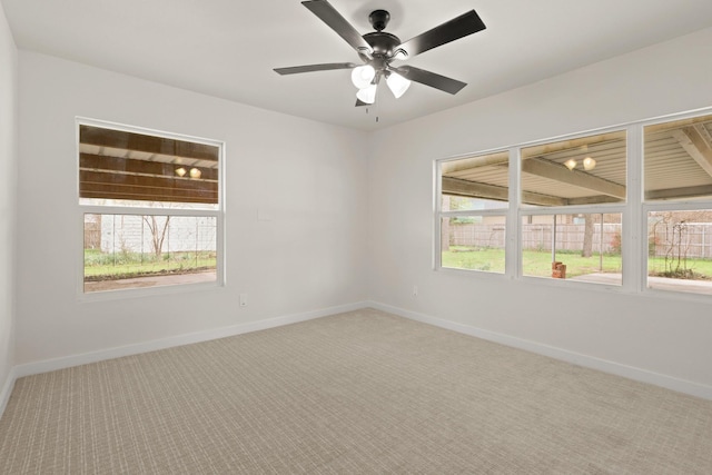 spare room featuring baseboards, carpet floors, and a ceiling fan