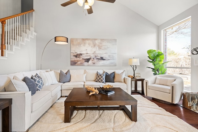 living room with a ceiling fan, light wood-style floors, and high vaulted ceiling