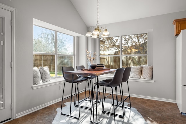 tiled dining space featuring an inviting chandelier, lofted ceiling, and baseboards