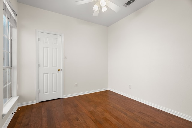 unfurnished room featuring visible vents, baseboards, ceiling fan, and wood-type flooring