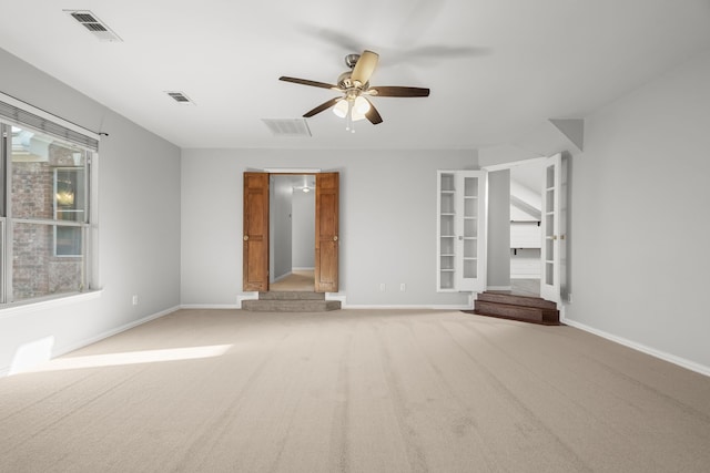 empty room with a ceiling fan, visible vents, and baseboards