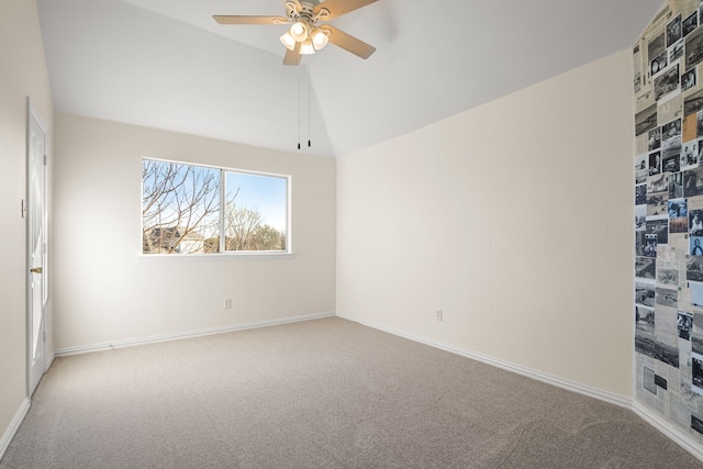 carpeted spare room featuring baseboards, lofted ceiling, and ceiling fan