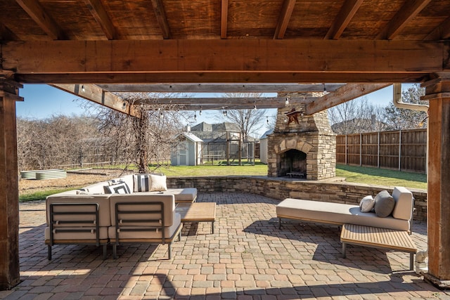 view of patio featuring an outbuilding, fence, a storage shed, and an outdoor living space with a fireplace