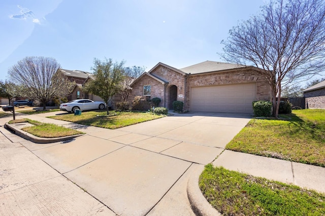 view of front of property with a front lawn, brick siding, an attached garage, and driveway