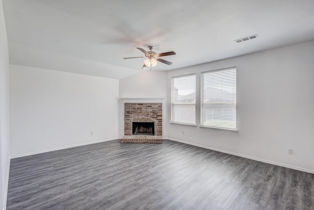 unfurnished living room featuring ceiling fan, baseboards, dark wood-style floors, and a fireplace