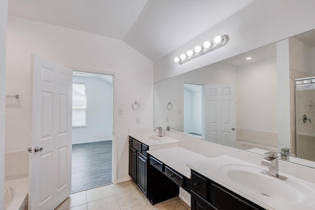 full bath featuring tile patterned flooring, vaulted ceiling, a garden tub, and a stall shower