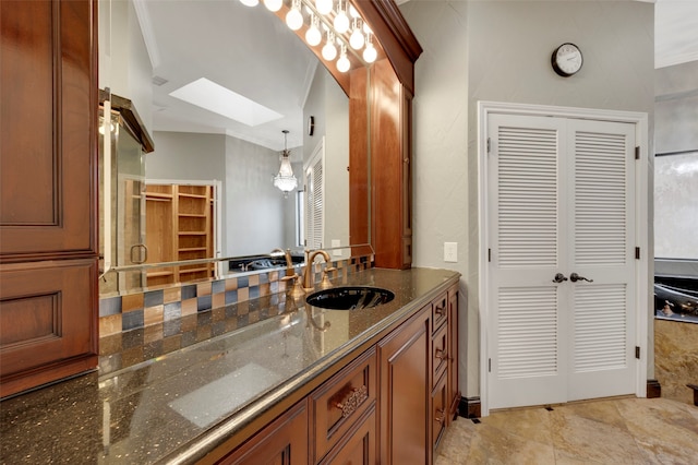 bathroom featuring a closet, a skylight, and vanity