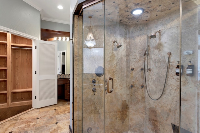 bathroom featuring a closet, vanity, a shower stall, and crown molding