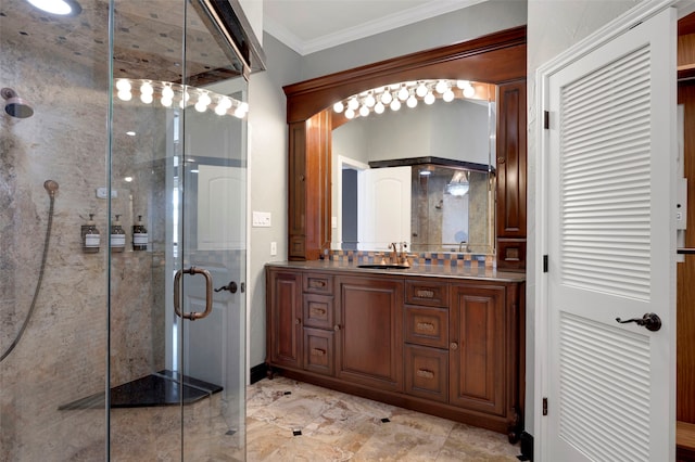 full bath with vanity, a shower stall, and ornamental molding