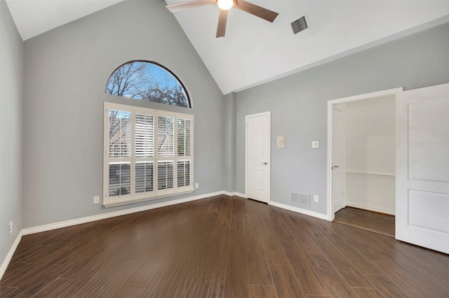 empty room with dark wood finished floors, a ceiling fan, visible vents, and baseboards