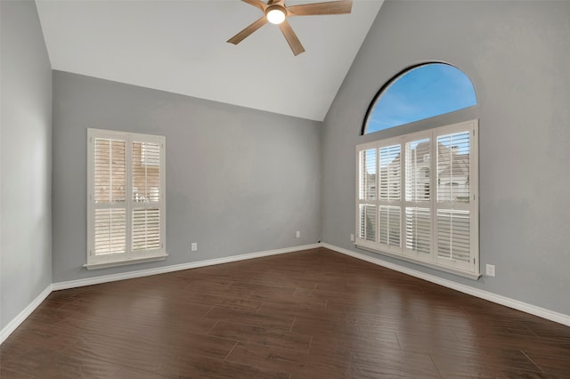 unfurnished room featuring a ceiling fan, wood finished floors, a healthy amount of sunlight, and baseboards