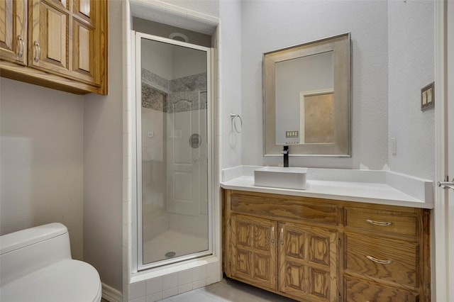 full bath featuring toilet, a stall shower, and vanity