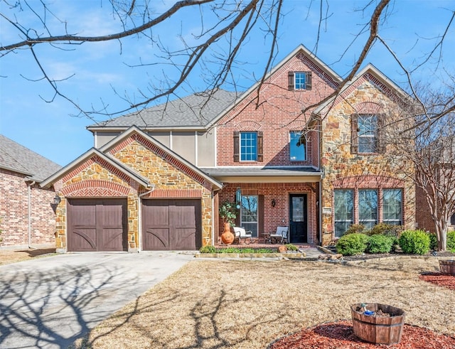 view of front of property with driveway, roof with shingles, an attached garage, stone siding, and brick siding